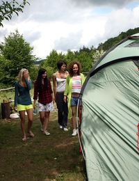 Four pretty teenage girls fondling bodies in a large tent